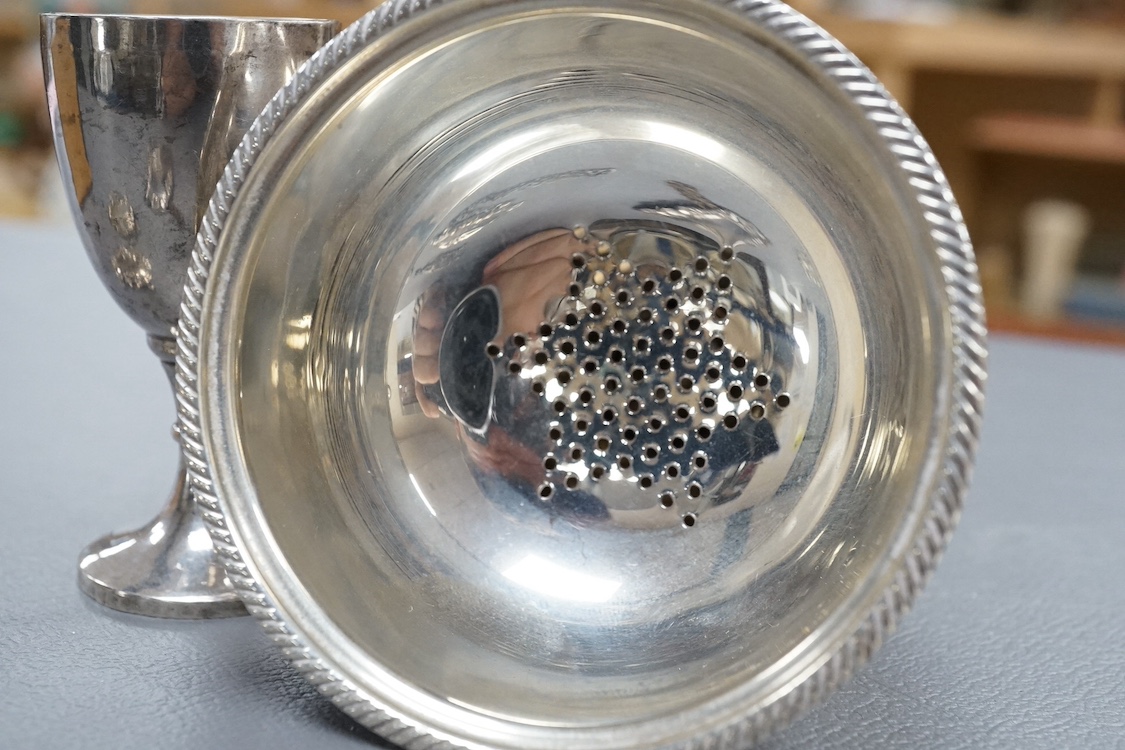 A modern silver wine funnel, with shell thumbpiece, L.J. Millington, Birmingham, 2000, 13.4cm, together with a small silver pedestal cup, three assorted sterling wine labels and three other wine labels including two plat